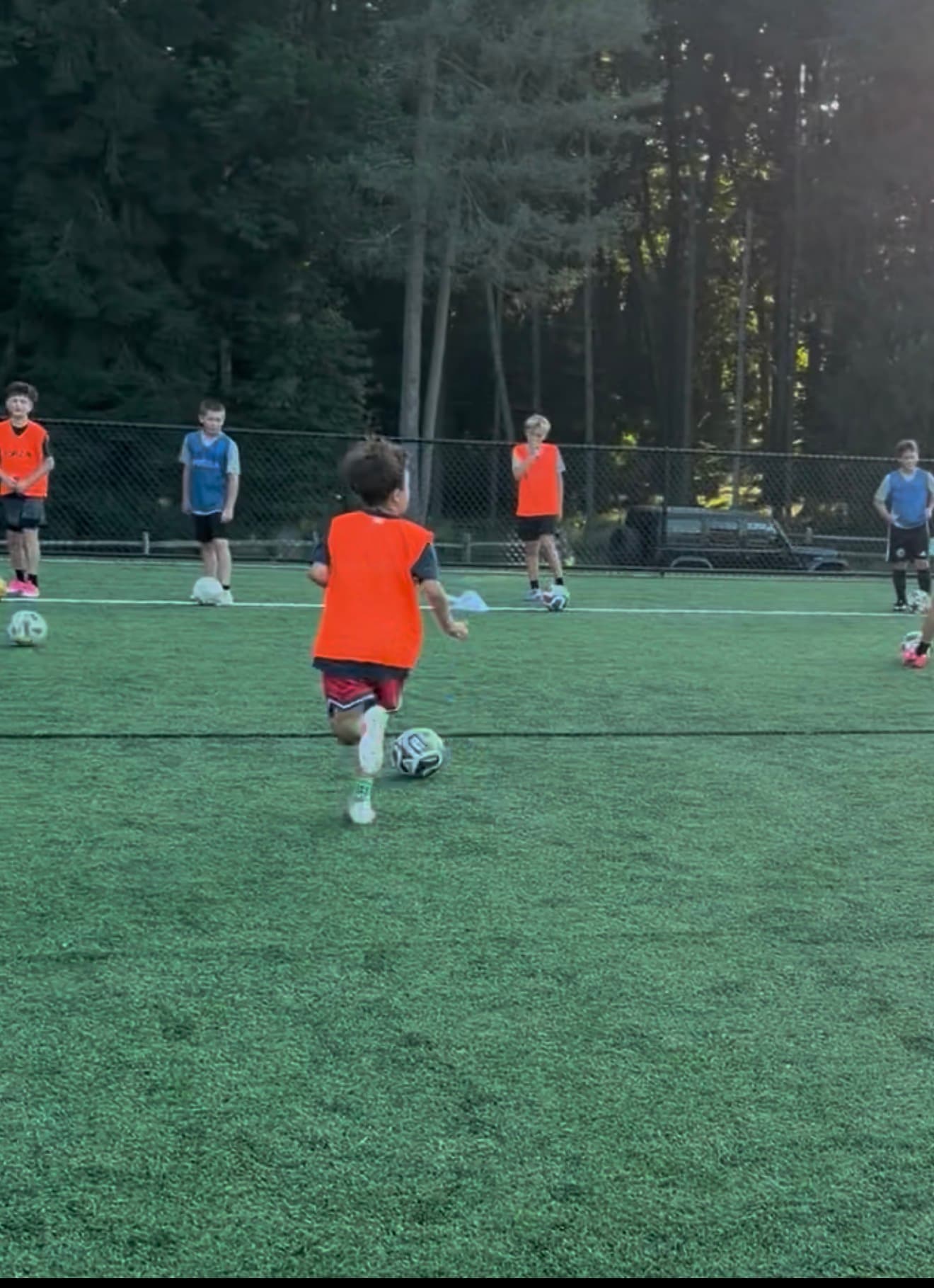 Young soccer player working with the ball during training